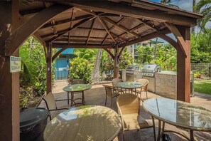 An outdoor patio with a covered seating area, a grill, and a sign instructing to clean up before leaving. - Kalama Terrace L203 South Kihei Retreat with Pool, Lanai, Ocean Nearby (Kihei)