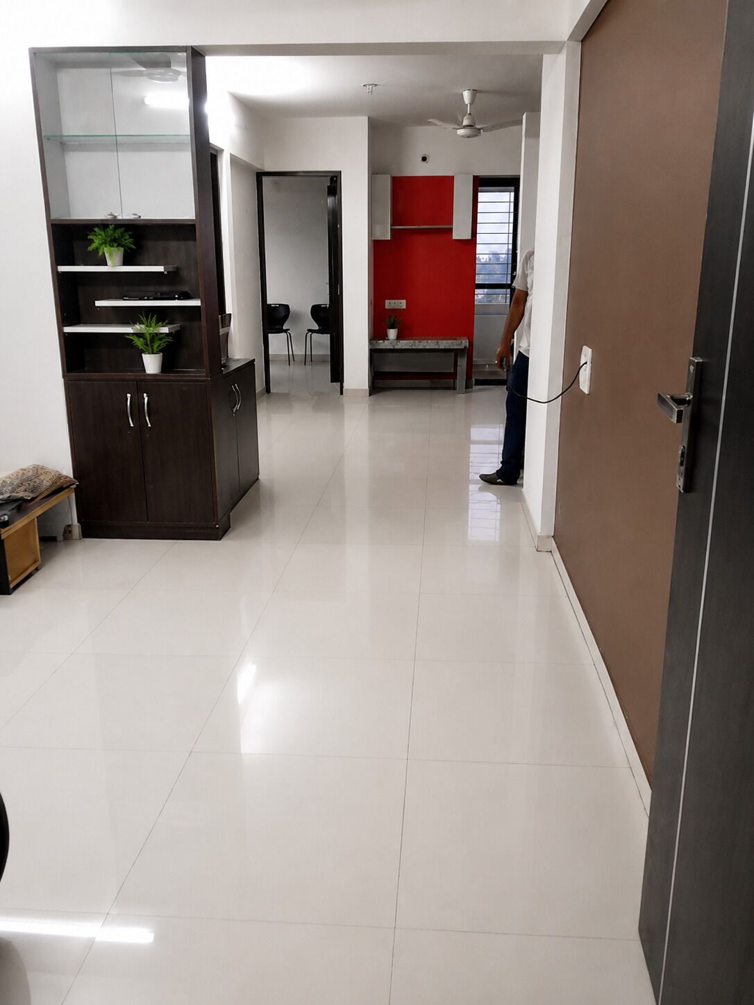 A modern interior with a kitchen area, a dining table, and a seating arrangement.