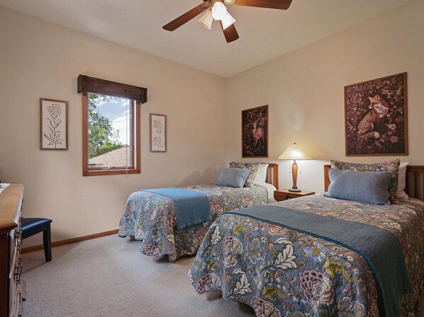 Upper level bedroom with two twin beds.