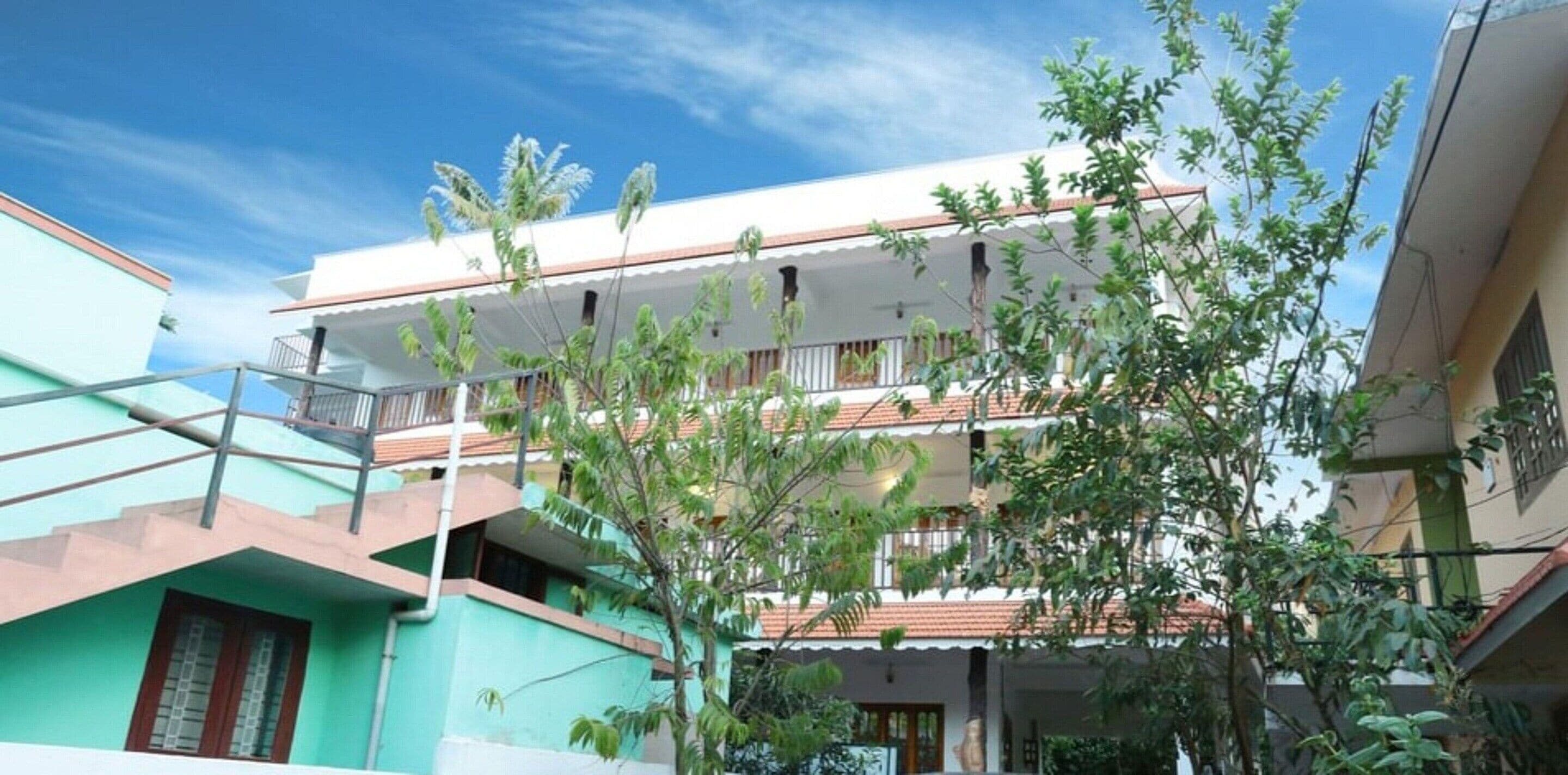 A multi-story residential building with balconies and a clear sky.