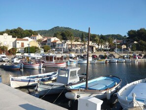 A marina with various boats docked, a hotel, and buildings in the background. - Les Aigues Marines by Interhome (Saint Cyr sur Mer La Madrague)