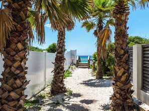 A sandy path leading to a beach with palm trees and a fence. - 🌴 Red Rooster | 30A Luxury Home | 3 Kings, Pool & Beach Access 🏖️ (Seacrest Beach)