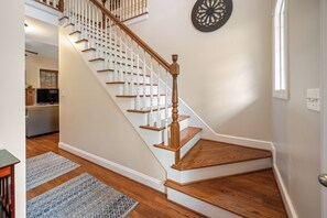 A staircase with white railings and wooden steps leading to an upper floor. - Boonsboro Escape (Lynchburg)