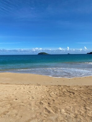 A beach with clear skies, calm sea, and distant islands. - Creole House on the Beach - Double Bed - Free Parking (Deshaies)