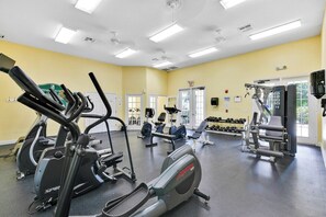 A gym with various exercise equipment, including treadmills, stationary bikes, and weight machines. - Venetian Bay Resort Townhouse w/ Pool & Gym Access (Kissimmee)