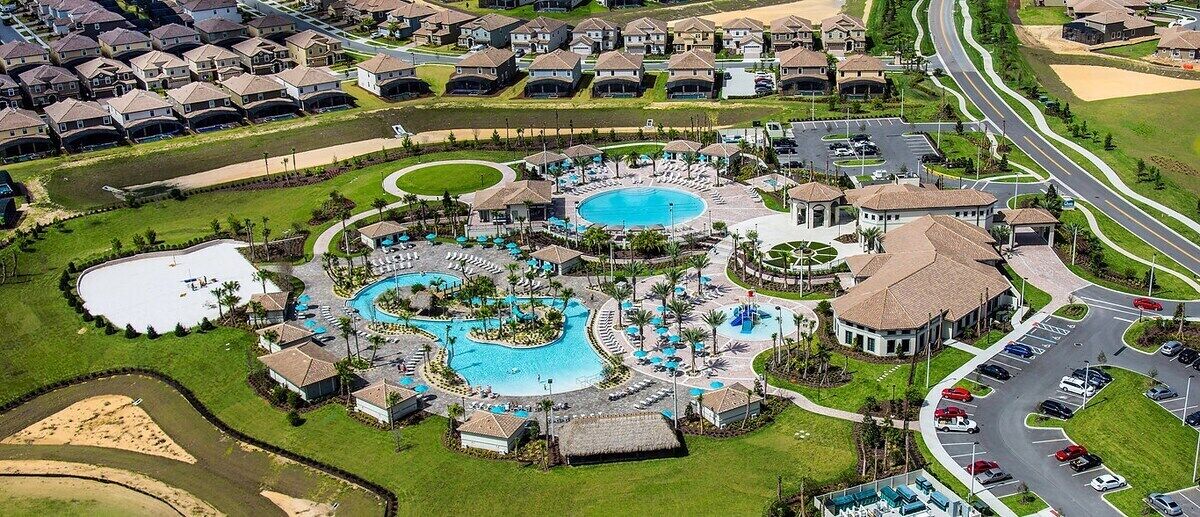 A resort with multiple swimming pools, a golf course, and a parking area.