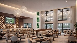 A modern dining area with round tables, chairs, and pendant lighting. - Kissimmee Villa 5BR Private Pool (Davenport)