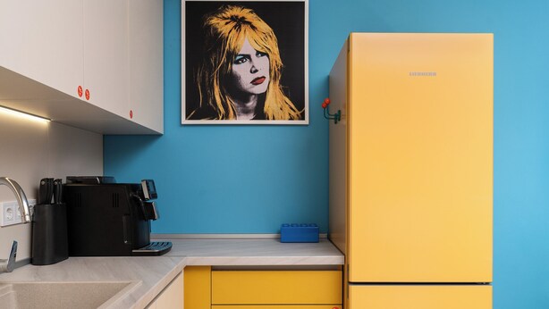 A kitchen with a yellow refrigerator, a blue wall, and a framed picture above the counter. - Pop-Art Apartment Sofia I 9 people I 3 Bedrooms I 3 Bathrooms I Design awarded (Sofia)