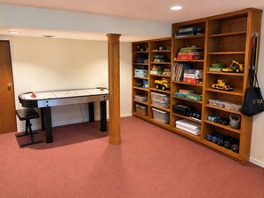 A room with a desk, a bookshelf, and a storage unit.