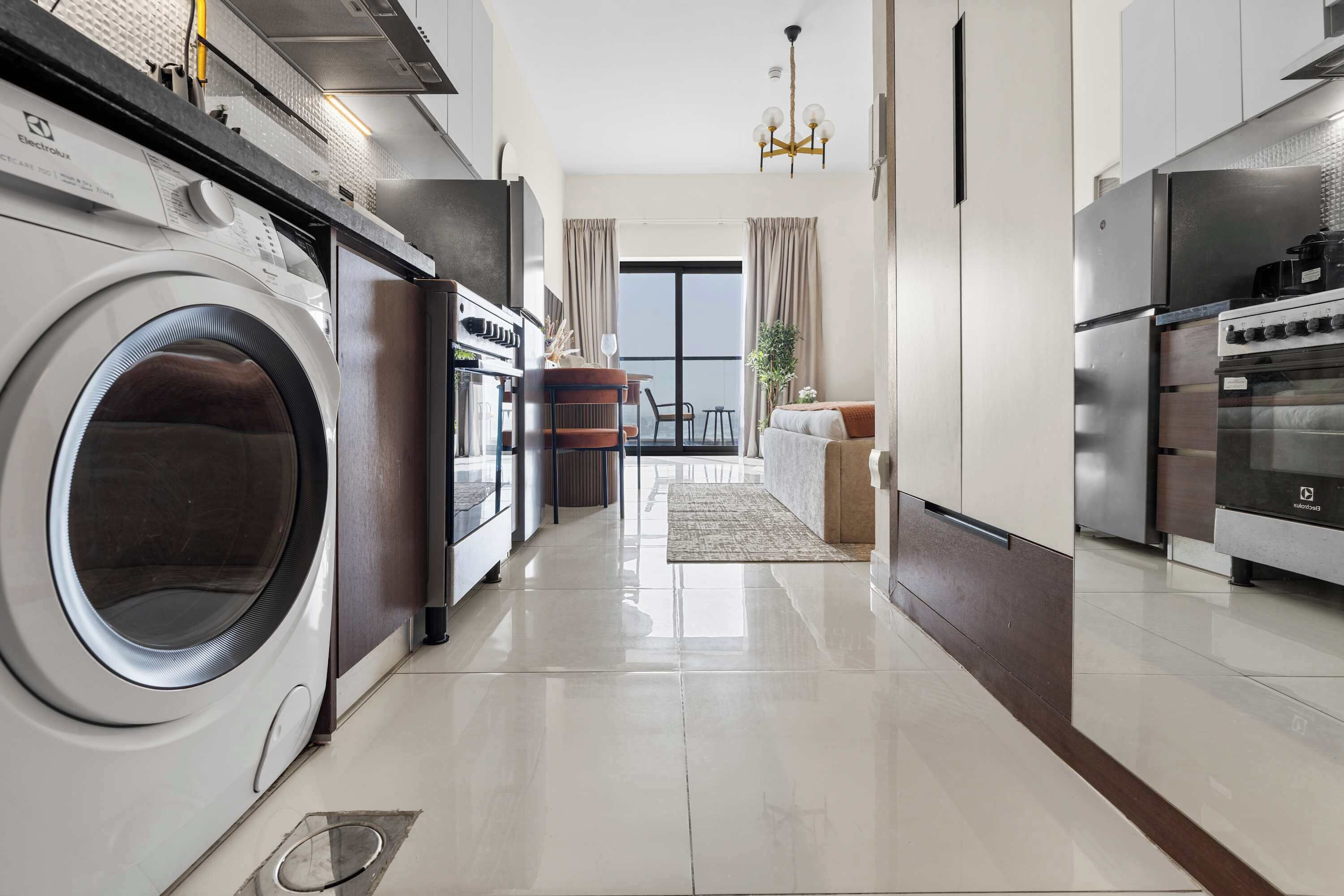 A modern kitchen with a built-in washer, oven, and stove.