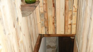 A wooden staircase with a shelf above it.
