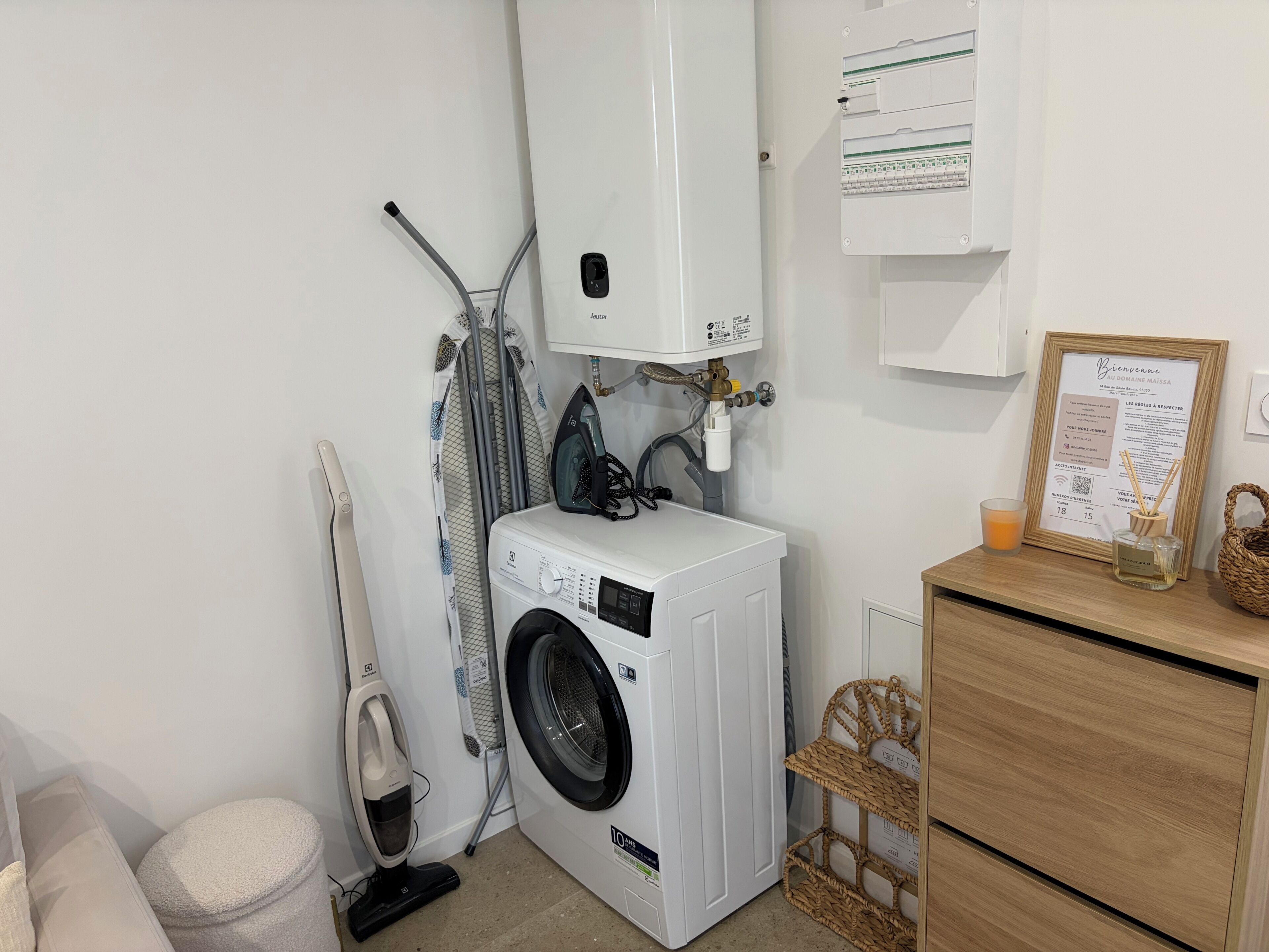 A laundry area with a washing machine, an iron, and a water heater.