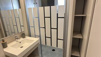 Shower, hair dryer, soap, toilet paper