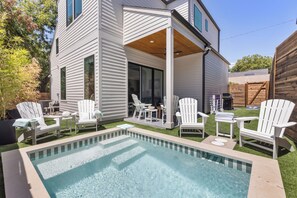 A modern house with a covered patio area featuring outdoor furniture and a swimming pool. - Tremendous 9-bedroom Luxury Compound - Two Pools & Two Houses (Austin)