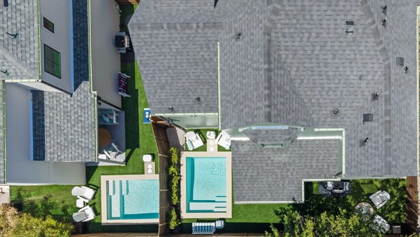 An aerial view of a hotel with a swimming pool, outdoor seating, and a parking area. - Tremendous 9-bedroom Luxury Compound - Two Pools & Two Houses (Austin)