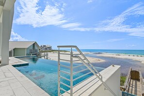 A clear blue pool with a diving board, overlooking a beach and ocean. - Salt and Sunshine|Gulf Front Estate|Private Pool|Golf Cart (Santa Rosa Beach)