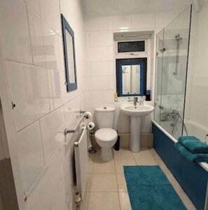 Ein Badezimmer mit Toilette, Waschbecken und Dusche.