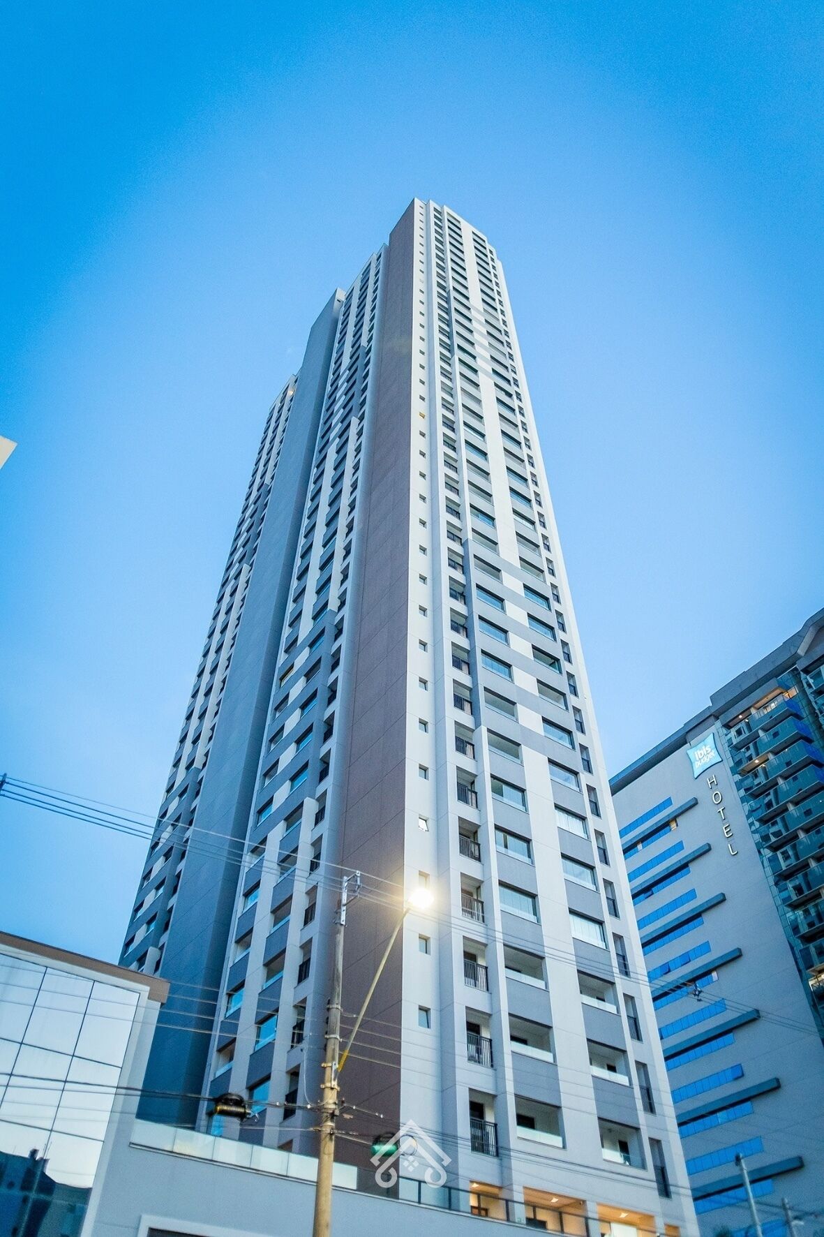 A high-rise hotel building with a modern design, featuring multiple floors and a prominent entrance.