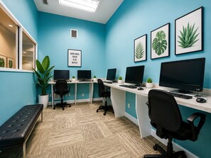 A modern office space with teal walls, multiple workstations, and potted plants. - 6-bedroom Lakeview Pool House in Resort at Kissimmee/No Carpet/Close to Parks (Kissimmee)