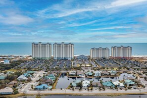 A coastal hotel complex with multiple high-rise buildings, a marina, and a parking area. - Beach Club Avalon Penthouse #1 - Luxury Beachfront 4BR, Views, Pool, Hot Tub (Gulf Shores)