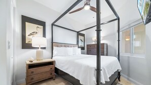 A four-poster canopy bed with a headboard, bedside tables, and a nightstand. - Beach Club Avalon Penthouse #1 - Luxury Beachfront 4BR, Views, Pool, Hot Tub (Gulf Shores)
