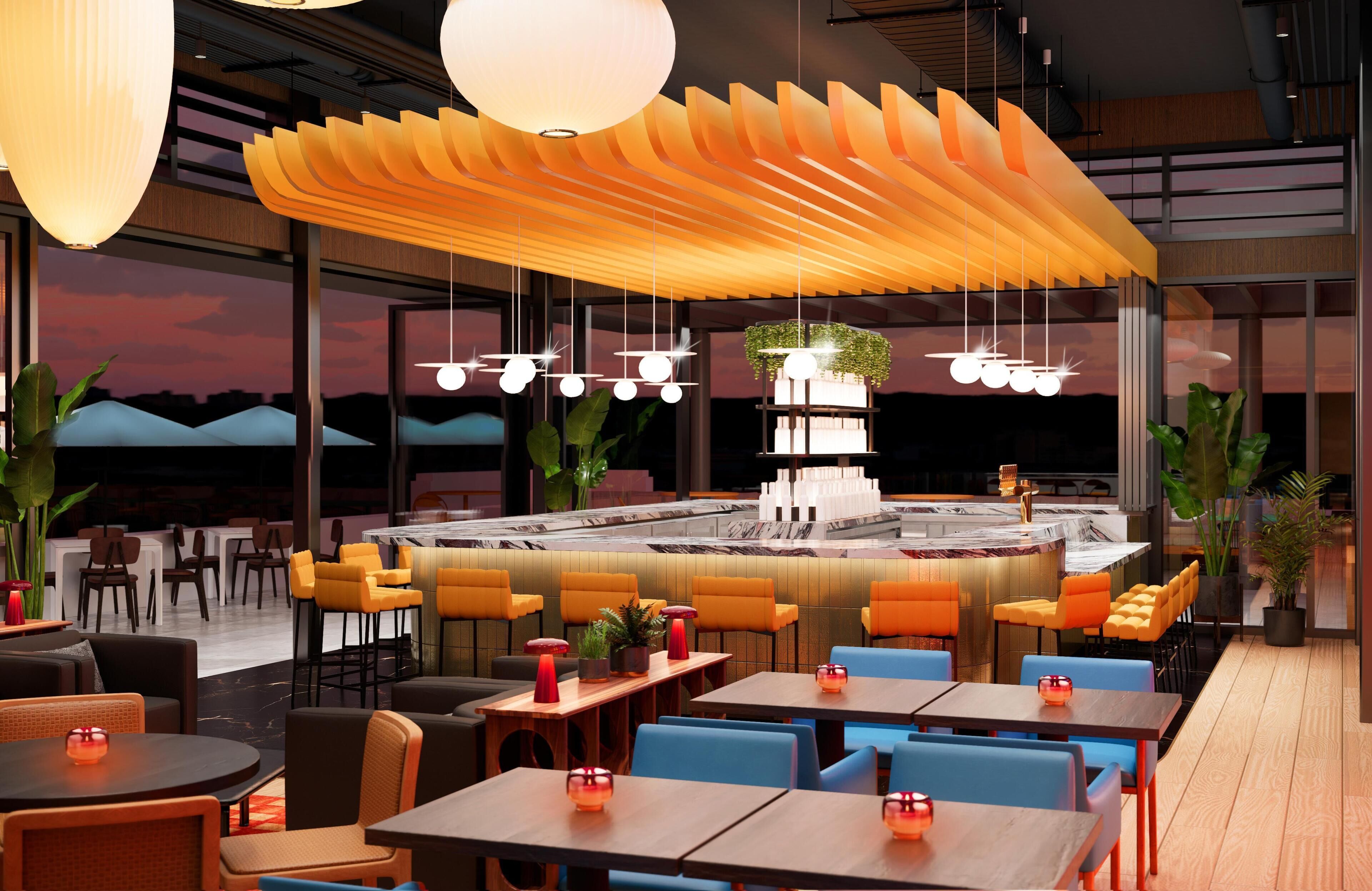 A modern restaurant with a central bar, multiple seating areas, and a view of the sunset.