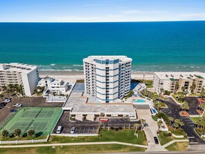 A high-rise hotel with a rooftop pool, a tennis court, and a beach view. - 🏖️ Seascape Towers 1025 | Direct Oceanfront Condo | Balcony + Pool Access (New Smyrna Beach)