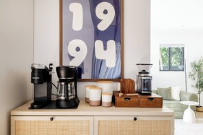 A kitchenette with a coffee maker, a blender, and storage containers on a wooden counter. - 4BR Miaminear Design Districtbig Yard & Fire Pit (Miami)