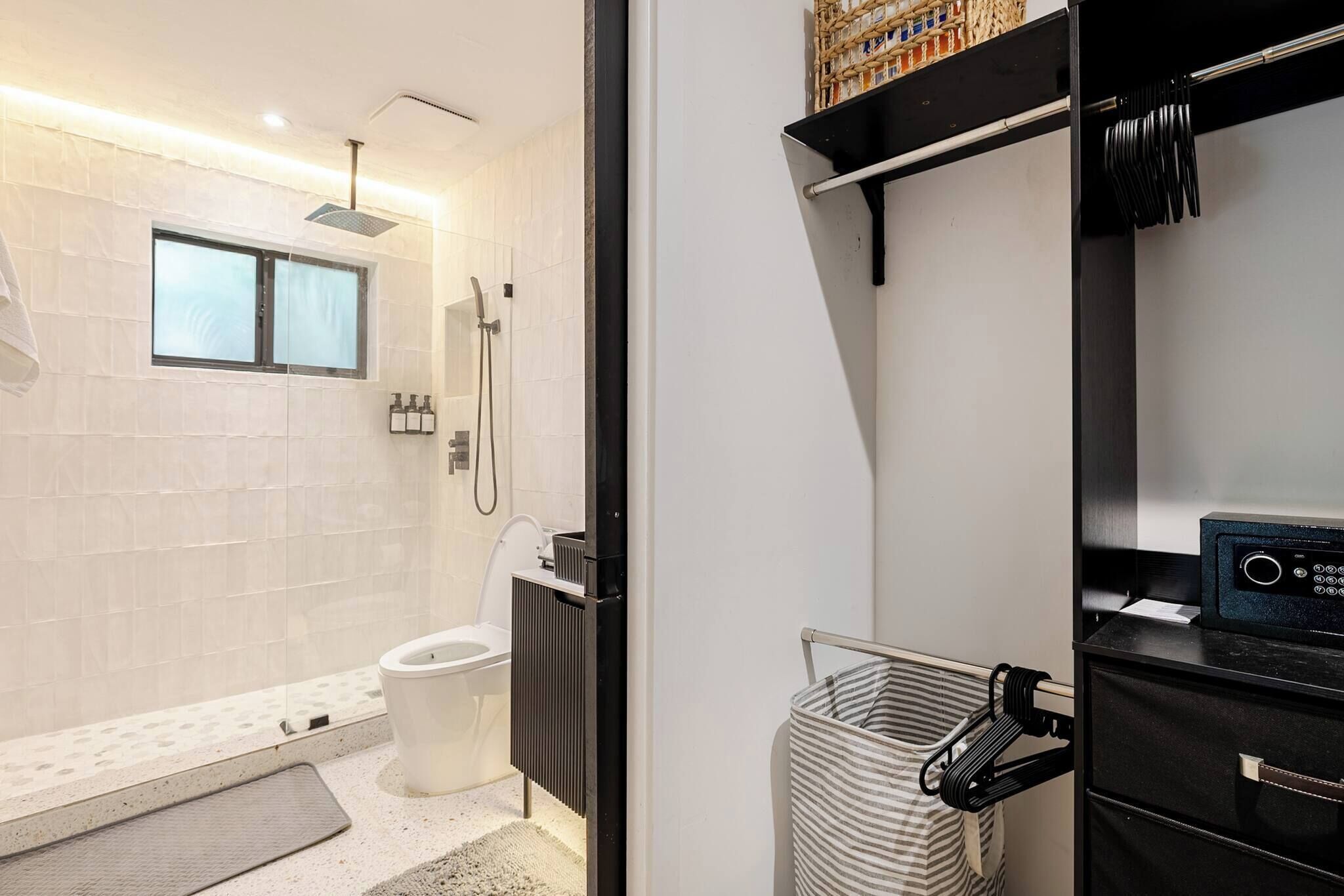Et moderne badeværelse med bruser, toilet og vaskebord med radio.
