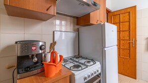 A kitchen with a stove, oven, and a coffee machine. - Apartment Lucia with Sea View, Wi-Fi, and Air Conditioning (Avola)