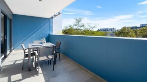 A balcony with a table and chairs, a bottle, and a glass. - The Terraces 220 - Two Bedroom Apartment, Sleeps 4 (Cape Town)