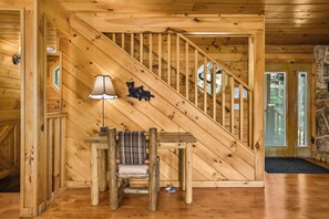 A wooden staircase with a lamp and a chair. - Sleeps 10, Game Room, Hot Tub, Two Fireplaces, 4 Mi to Downtown Gatlinburg (Gatlinburg)
