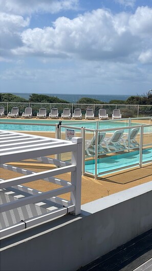 A pool area with lounge chairs and a view of the sea. - ☀️ Getaway with a sea view • Swimming Pools • Wild Coast (Les Sables-d'Olonne)