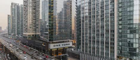 A high-rise building with a prominent 'ONE YORK' sign, surrounded by other tall buildings and busy traffic.