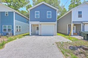 A two-story residential building with a garage, a driveway, and a small front yard. - Pilgrim Luxury #4. New Construction with a Hot tub (Hanahan)