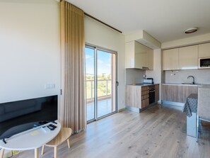 A modern apartment with a living room, dining area, kitchen, and a sliding glass door to a balcony. - Apartment  by Interhome (Praia da Rocha)