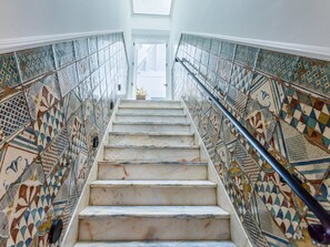 A staircase with patterned tiles on the walls and a handrail on the right. - TaviraBliss Terrace Apartment by Interhome (Tavira)