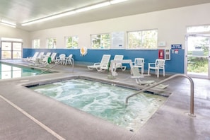 A pool area with lounge chairs and a hot tub. - WM BLOCK Discovery Bay 2br (Port Townsend)