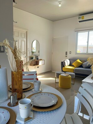 A modern living room with a dining area, a sofa, and a coffee table. - Home in San Miguel (San Miguel)