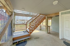 A wooden staircase leading to an upper deck with a view of the surrounding area. - "Pipe Dreams" -- 50 Steps To Beach, Gulf View, Dog Friendly, Super Cute 3BR Home (Gulf Shores)