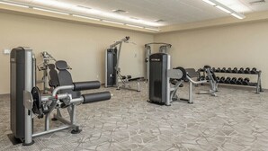A hotel fitness center with various exercise equipment, including weight machines and dumbbells. - Phoenix Orange Beach 1202 (Orange Beach)