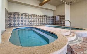 A spa area with two hot tubs and a tiled wall. - Phoenix Orange Beach 1202 (Orange Beach)