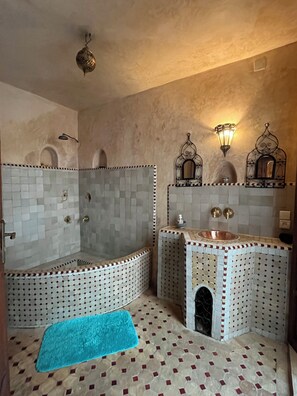 Une salle de bain avec une baignoire, un lavabo et une douche.