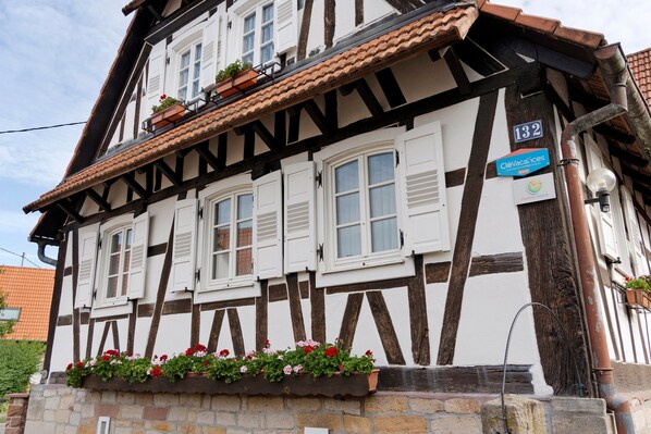 A traditional half-timbered building with a sign indicating it is a hotel.