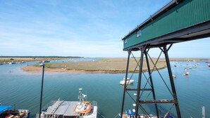 A coastal view with a green pier and boats in the water. - 1 Bed in Wells-next-the-Sea (oc-591) (Wells-next-the-Sea)