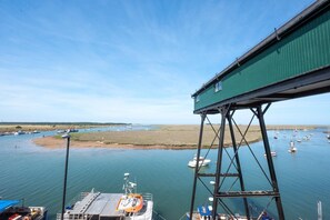 A coastal view with a green pier and boats in the water. - 1 Bed in Wells-next-the-Sea (oc-591) (Wells-next-the-Sea)