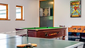 A pool table with a dartboard and a poster of Iron Man. - 3 Bed in Kilkhampton (oc-l27383) (Kilkhampton)