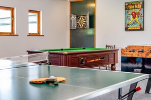 A pool table with a dartboard and a poster of Iron Man. - 3 Bed in Kilkhampton (oc-l27383) (Kilkhampton)