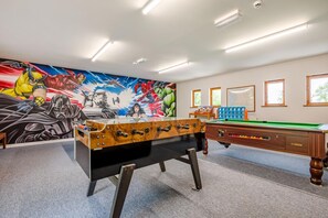 A room with a pool table, a foosball table, and a Star Wars-themed mural on the wall. - 3 Bed in Kilkhampton (oc-l27383) (Kilkhampton)