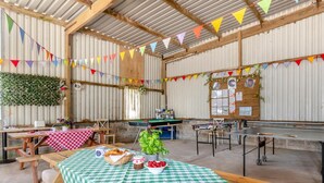 A rustic indoor space with wooden tables, a pool table, and a green checkered tablecloth. - 1 Bed in Haverfordwest (oc-b32913) (Dale)